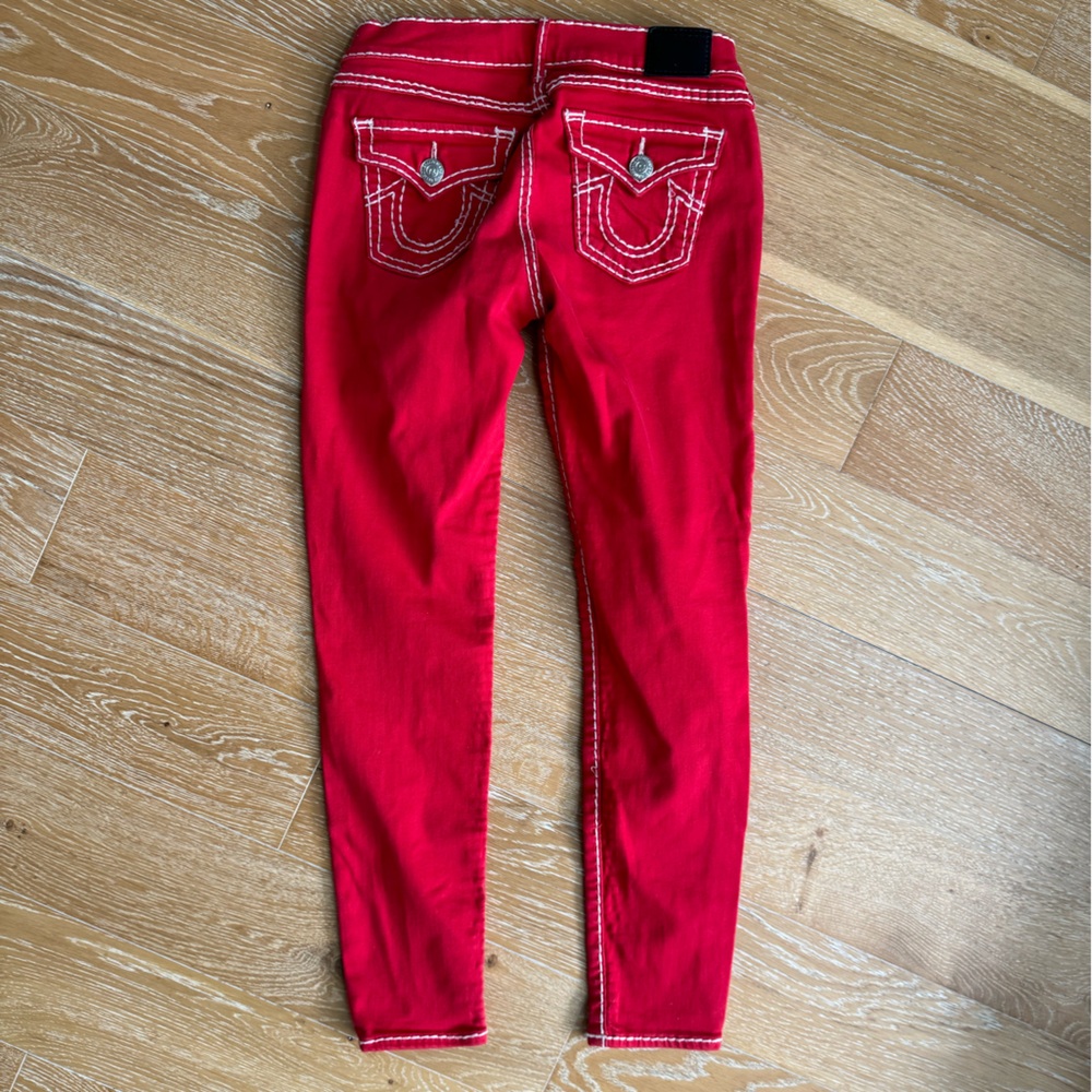 Red with white stitching, super skinny low rise True Religion jeans.